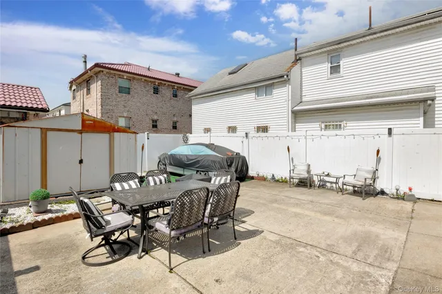 a view of a patio with table and chairs and barbeque stove