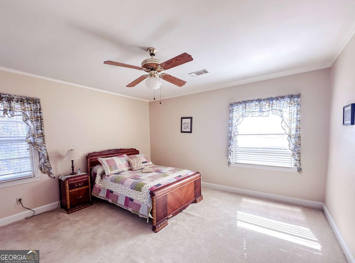 1106 Mt Vernon Road Vidalia, GA 30474 - Photo 13 of 24 a bedroom with a bed bed and a window