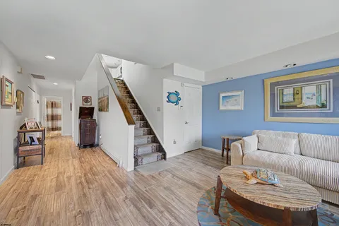 a living room with furniture and a wooden floor