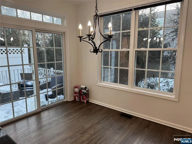 a view of a room with wooden floor and windows