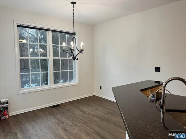 a view of a workspace with furniture and window