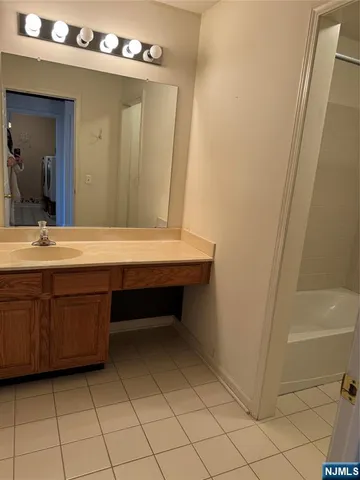 a bathroom with a sink a vanity and a mirror