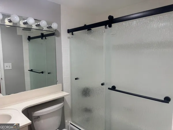 a bathroom with a sink and shower