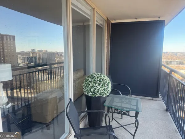 a balcony with furniture and wooden floor