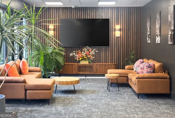 a living room with furniture and a flat screen tv