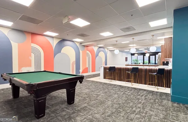 a room with furniture a air conditioner vent and a window