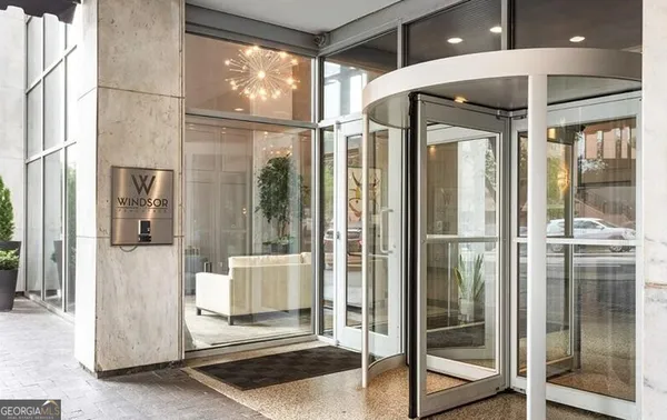 a bathroom with a glass shower door and a glass door