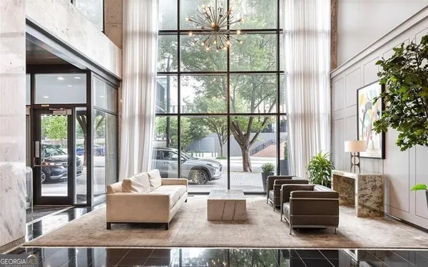 a living room with fireplace furniture and a large window