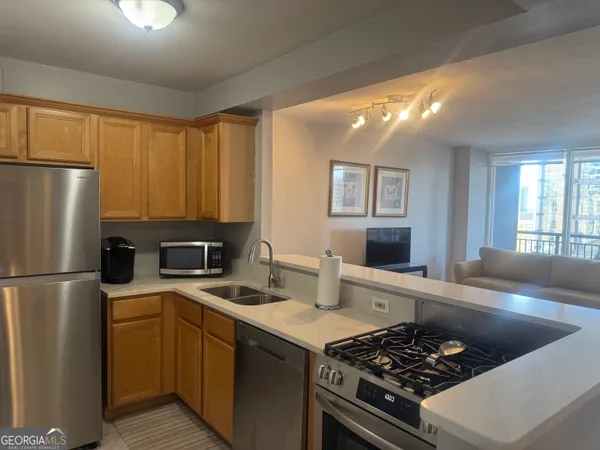 a kitchen with a stove a refrigerator and a sink
