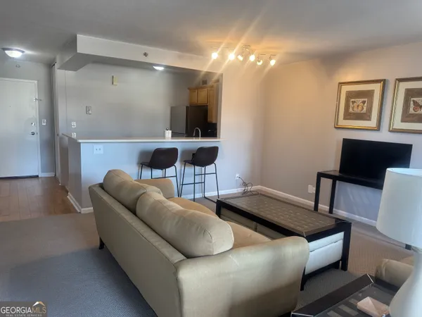 a living room with furniture and a lamp