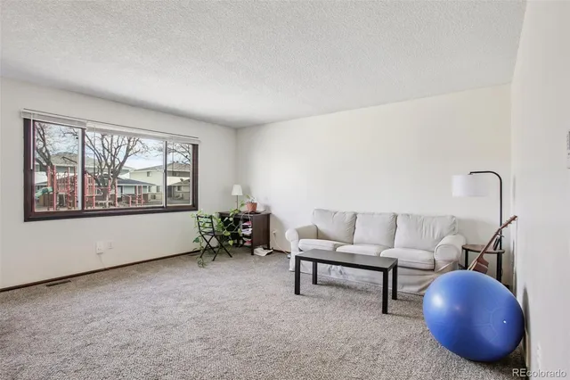 a bathroom with a granite countertop sink a toilet and a mirror