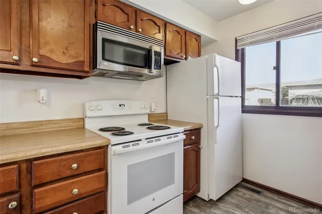 a view of kitchen with furniture and a refrigerator