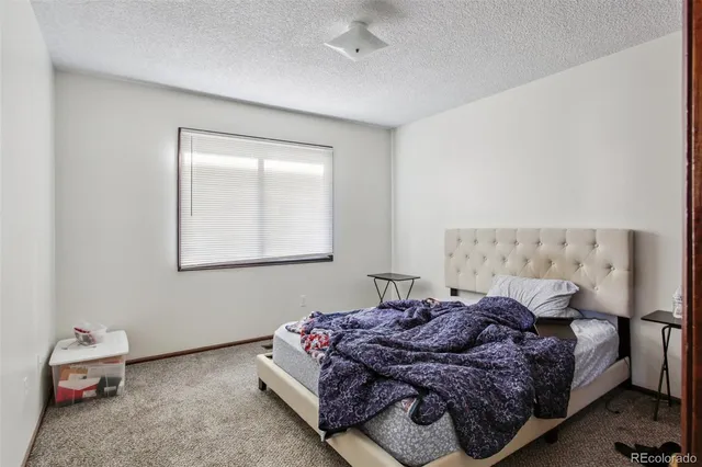 a bedroom with bed and window