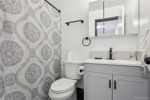 a kitchen with a sink a stove and cabinets