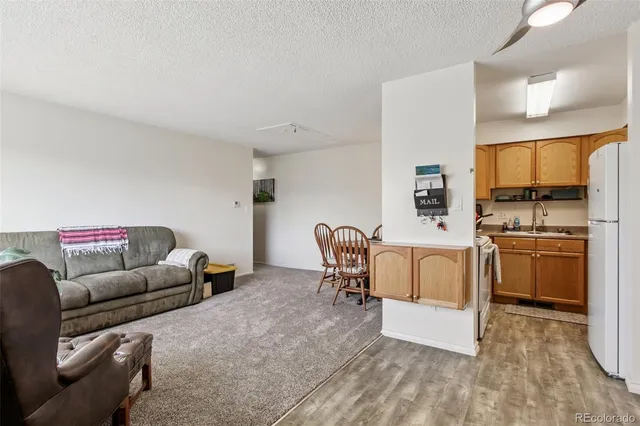 a bathroom with a granite countertop sink a toilet and a mirror