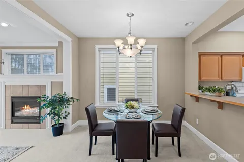 a view of a dining room with furniture and chandelier
