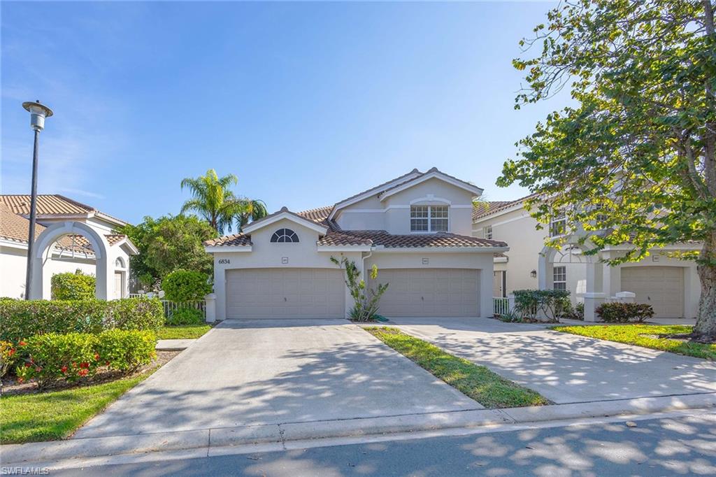a front view of a house with a yard and a porch