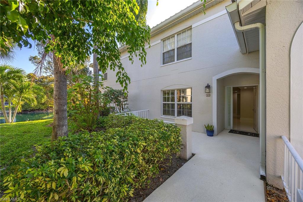 6834 Lantana Bridge Road, Unit 101 Naples, FL 34109 - Photo 14 of 50 front view of a house with a yard