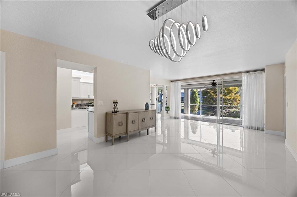 6834 Lantana Bridge Road, Unit 101 Naples, FL 34109 - Photo 17 of 50 a living room with furniture and a large window