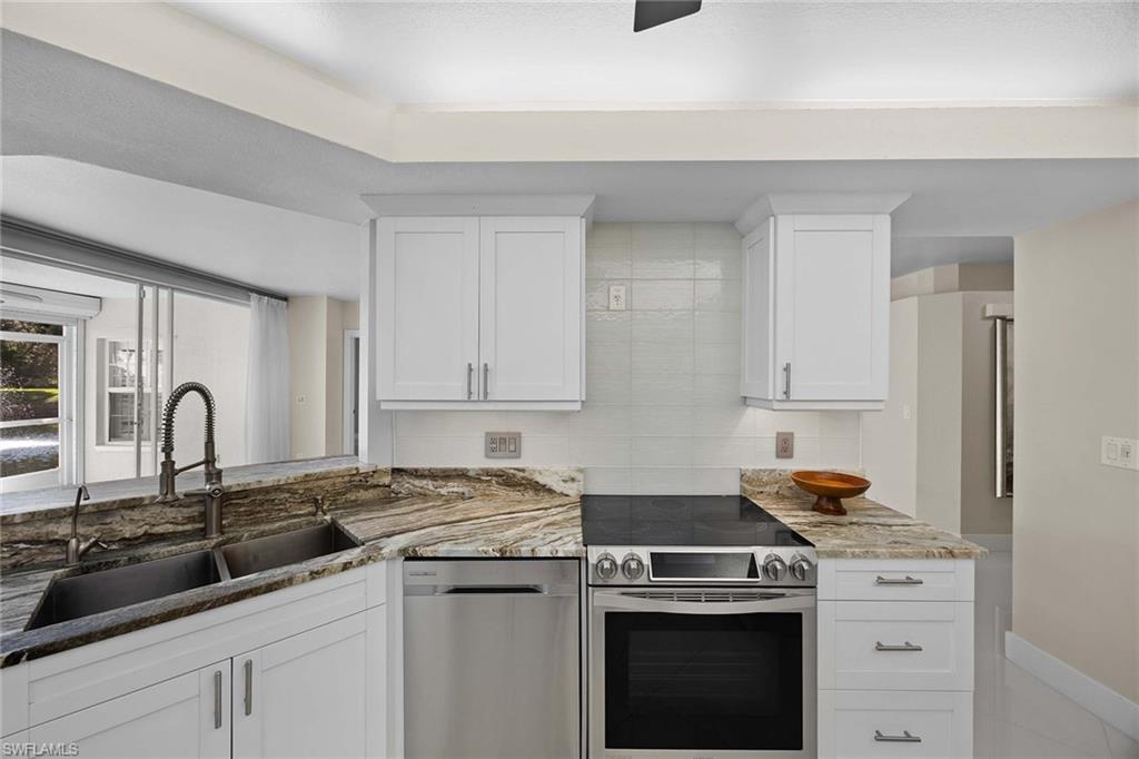 6834 Lantana Bridge Road, Unit 101 Naples, FL 34109 - Photo 22 of 50 a kitchen with a sink stove and cabinets