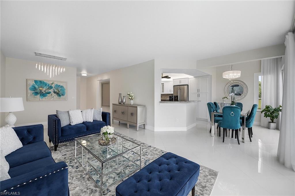 6834 Lantana Bridge Road, Unit 101 Naples, FL 34109 - Photo 3 of 50 a living room with furniture and a wooden floor