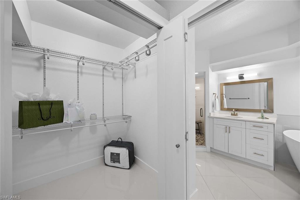 6834 Lantana Bridge Road, Unit 101 Naples, FL 34109 - Photo 33 of 50 a room with mirror and window