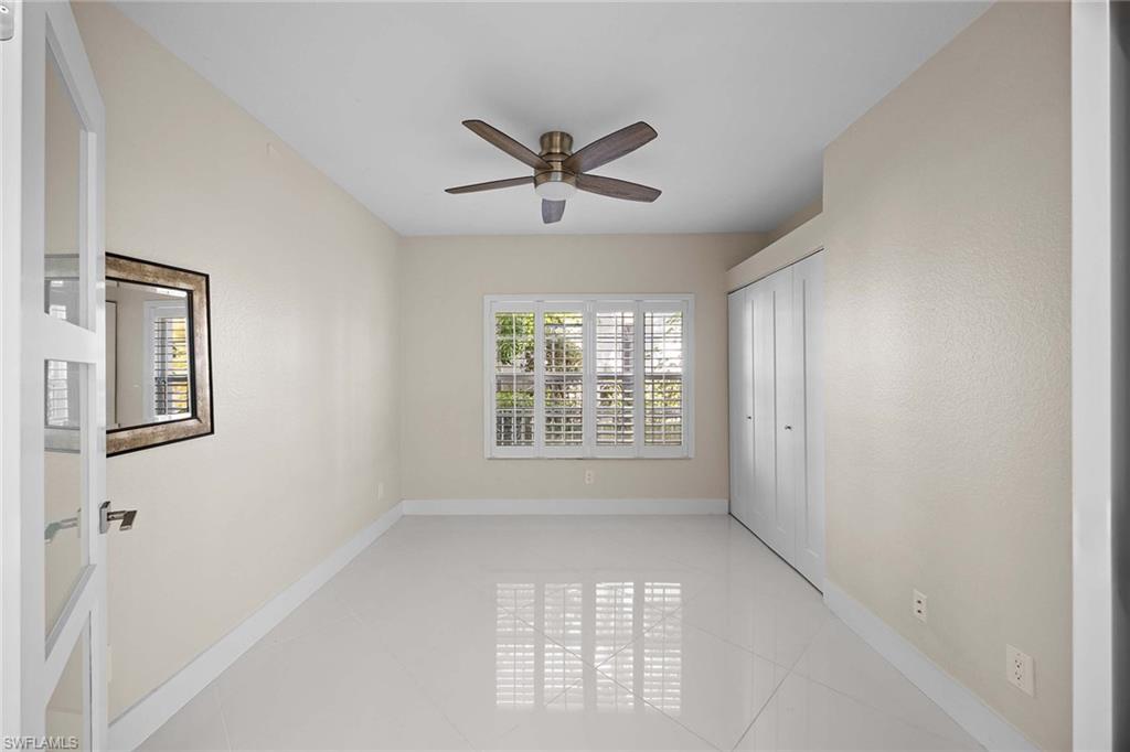 6834 Lantana Bridge Road, Unit 101 Naples, FL 34109 - Photo 34 of 50 a view of an empty room with a window