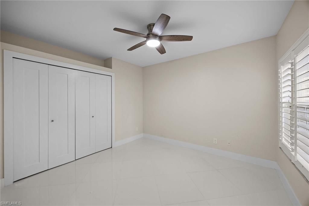 6834 Lantana Bridge Road, Unit 101 Naples, FL 34109 - Photo 35 of 50 an empty room with fan and windows
