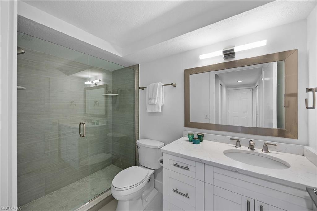 6834 Lantana Bridge Road, Unit 101 Naples, FL 34109 - Photo 36 of 50 a bathroom with a sink a toilet and shower