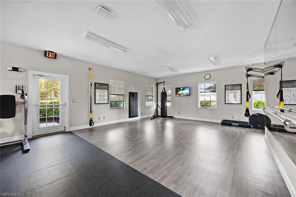 6834 Lantana Bridge Road, Unit 101 Naples, FL 34109 - Photo 43 of 50 a view of an empty room with window and wooden floor