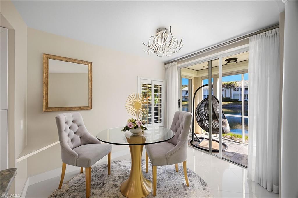 6834 Lantana Bridge Road, Unit 101 Naples, FL 34109 - Photo 7 of 50 a view of a dining room with furniture and a chandelier