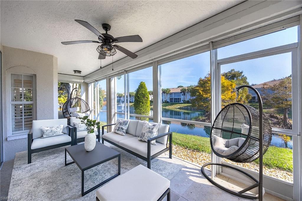 6834 Lantana Bridge Road, Unit 101 Naples, FL 34109 - Photo 8 of 50 a living room with furniture and a floor to ceiling window