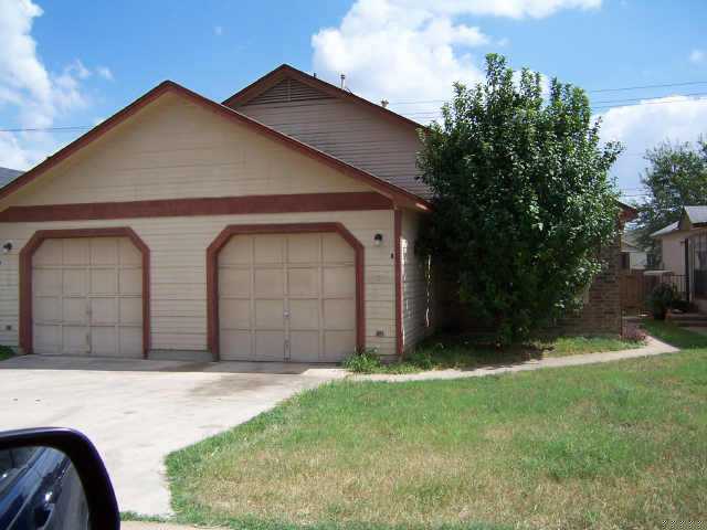 9404 Manchaca Road Austin, TX 78748 - Photo 1 of 1 a front view of a house with garden