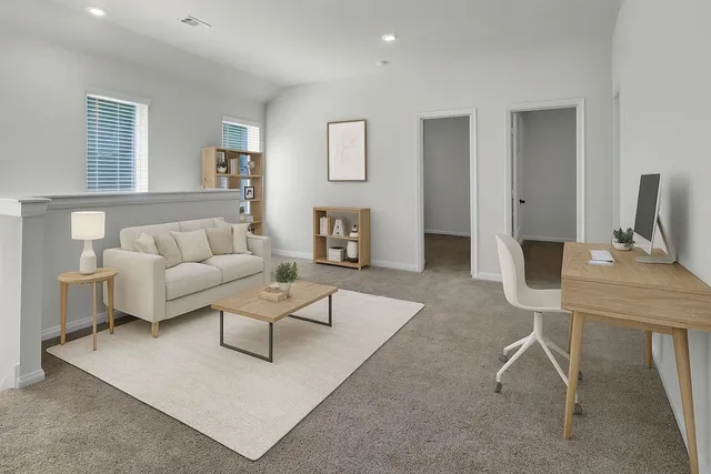 a living room with furniture and a table