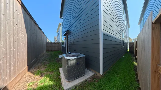 a view of small yard in front of house with wooden fence