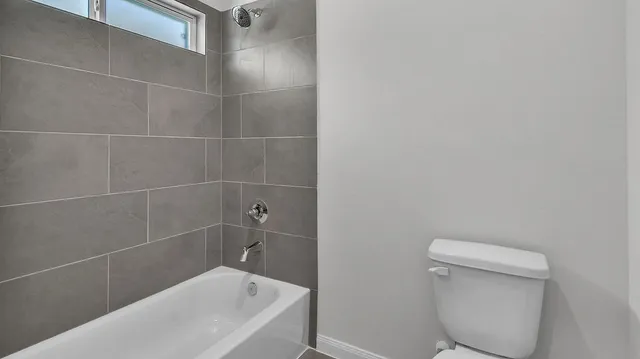 a bathroom with a toilet and bathtub