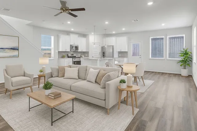 a living room with furniture and a wooden floor