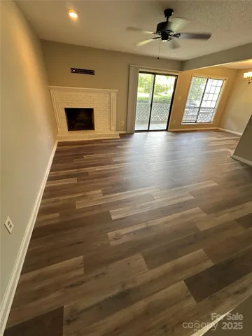 wooden floor in an empty room with a fireplace