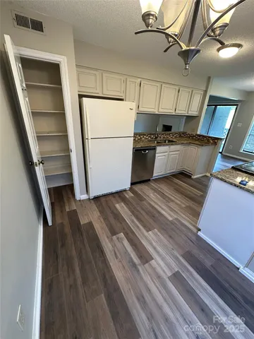 a view of a room with wooden floor and staircase