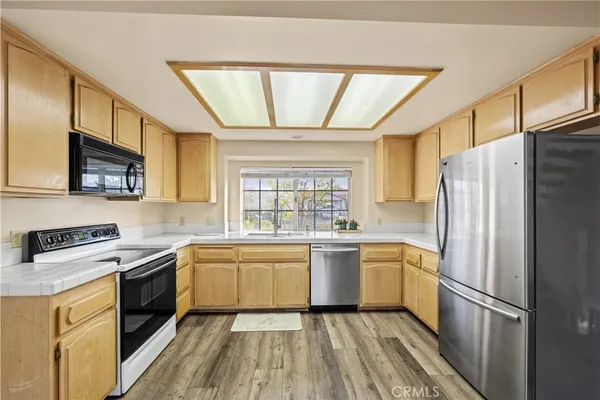 a kitchen with a refrigerator stove and sink
