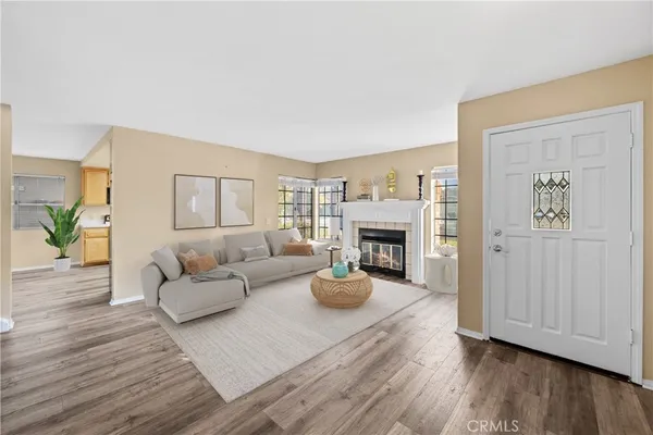 a living room with fireplace furniture and a wooden floor