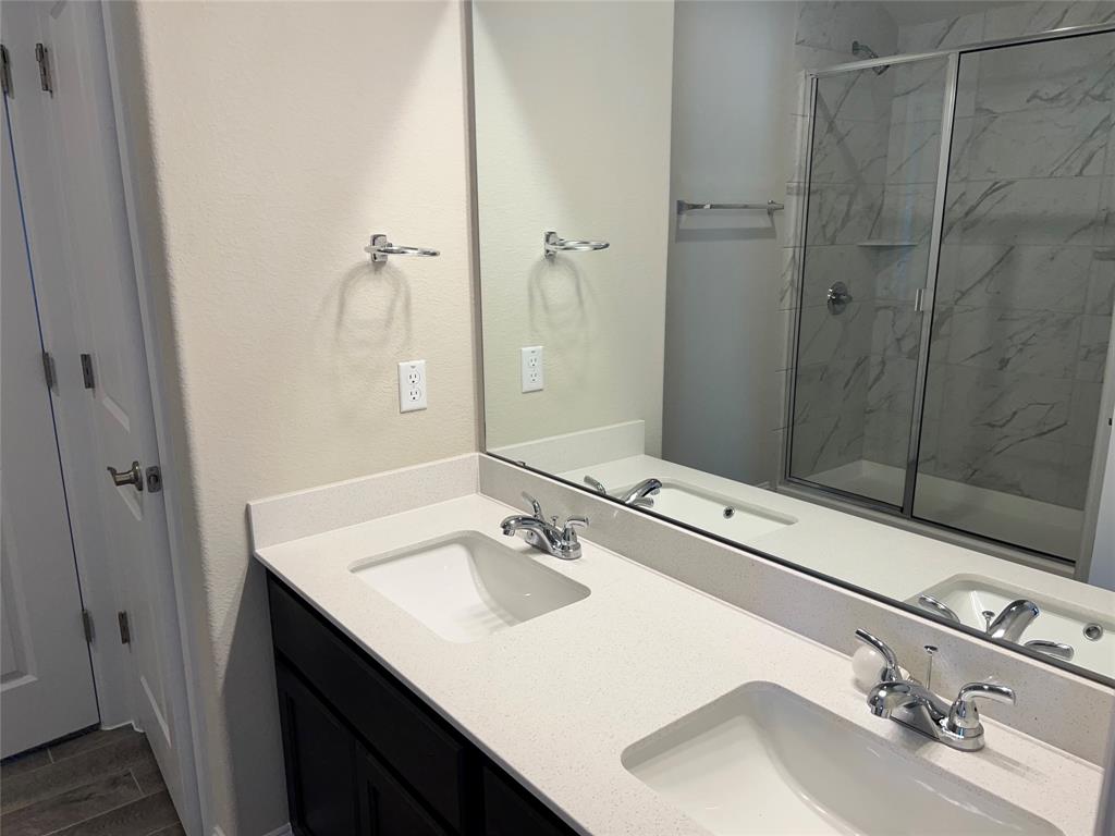 128 Free Stone Drive Georgetown, TX 78628 - Photo 12 of 29 Double vanity featuring white integrated sinks and chrome fixtures