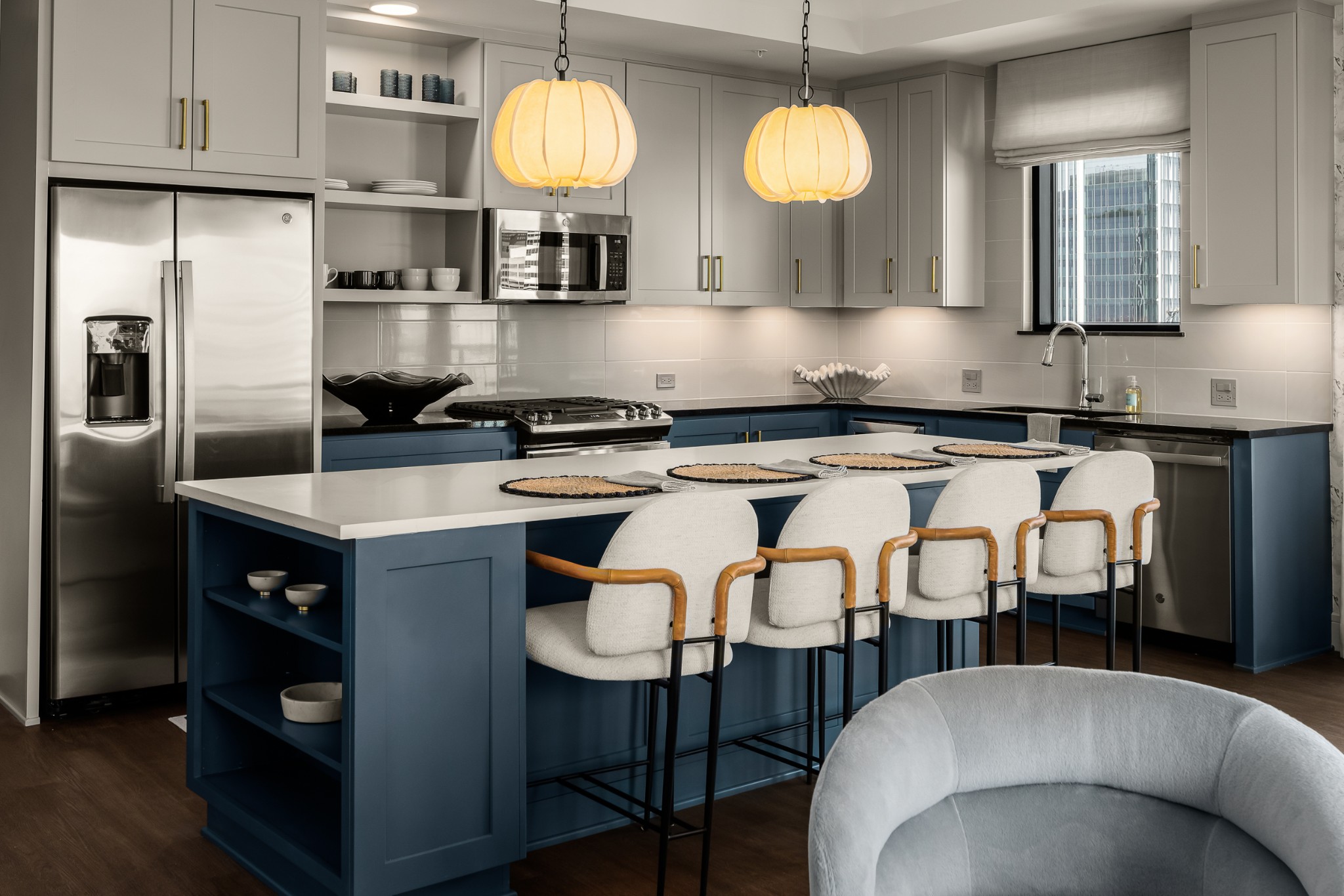 930 Commerce Street, Unit 2 Nashville, TN 37203 - Photo 14 of 57 a kitchen with stainless steel appliances granite countertop a sink a stove a refrigerator cabinets and chairs