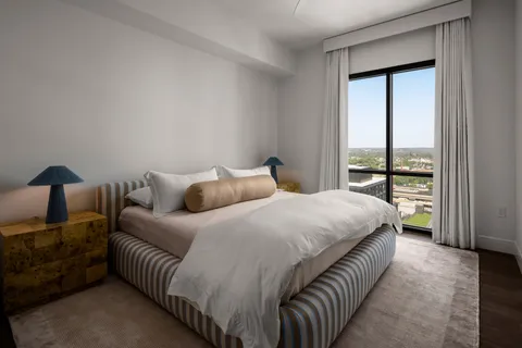 a bedroom with a bed and a lamp