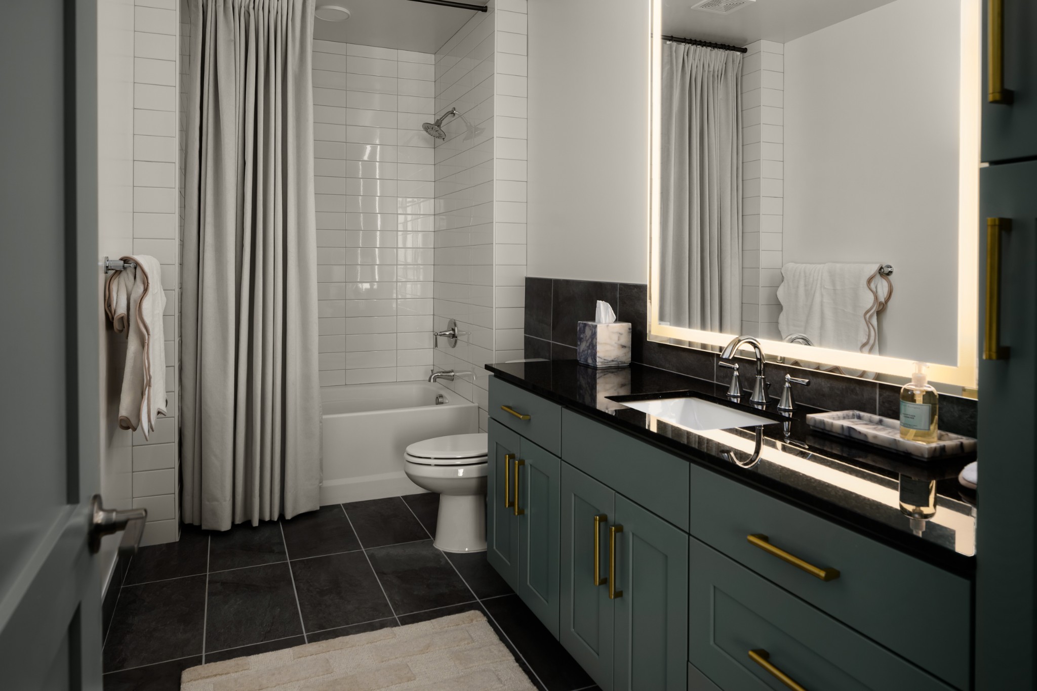 930 Commerce Street, Unit 2 Nashville, TN 37203 - Photo 6 of 57 a bathroom with a granite countertop sink a toilet and a mirror