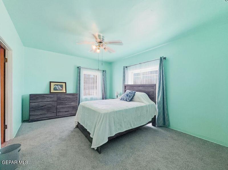 4135 Emory Road El Paso, TX 79922 - Photo 53 of 73 a bedroom with a bed and a chandelier