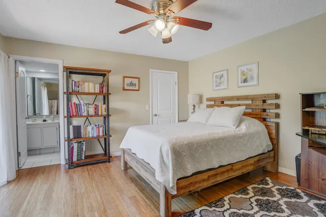 a bed room with a bed and a book shelf