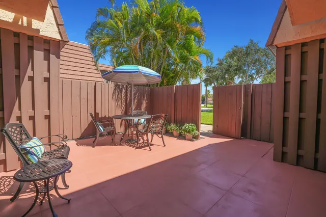 a view of a chairs and table in patio