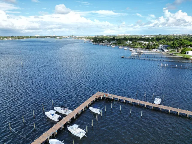 a front view of a house with a yard and lake view