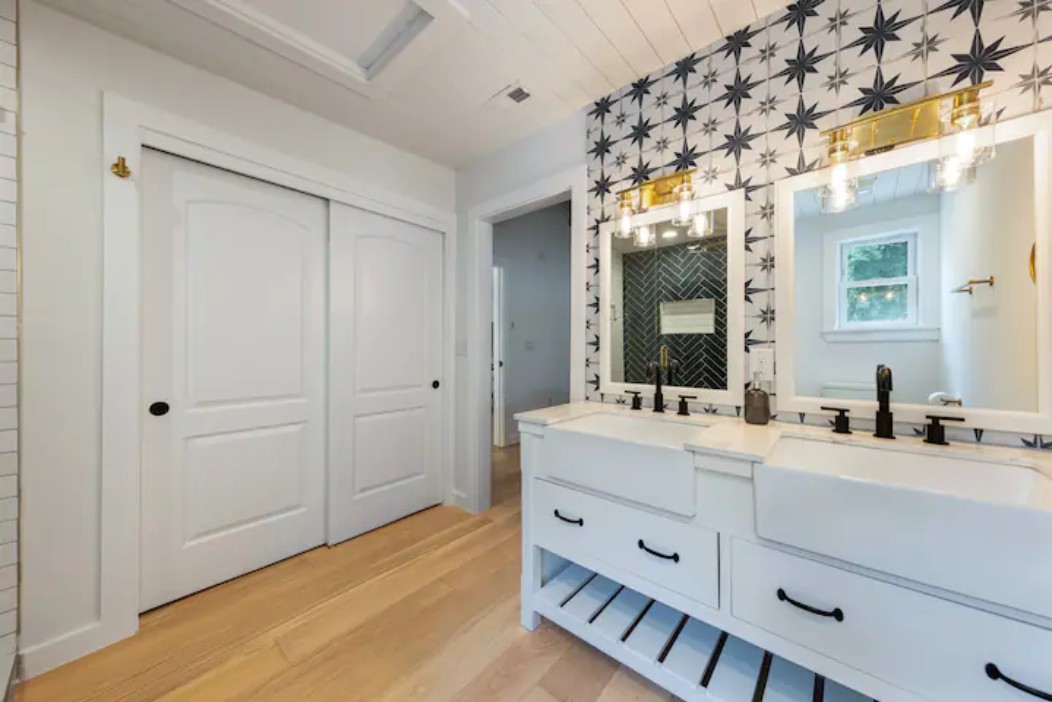 2319 Santa Rita Street Austin, TX 78702 - Photo 10 of 26 Bathroom with double vanity and light wood-style flooring